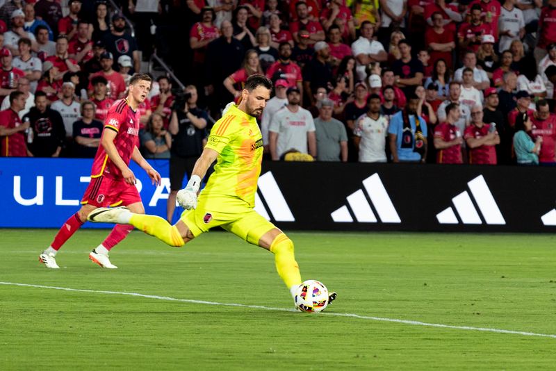 Goalkeeper in a neon yellow kit taking a goal kick in front of a packed stadium crowd